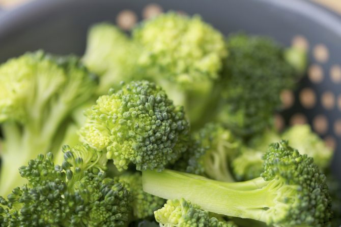 Broccoli florets in grey colander